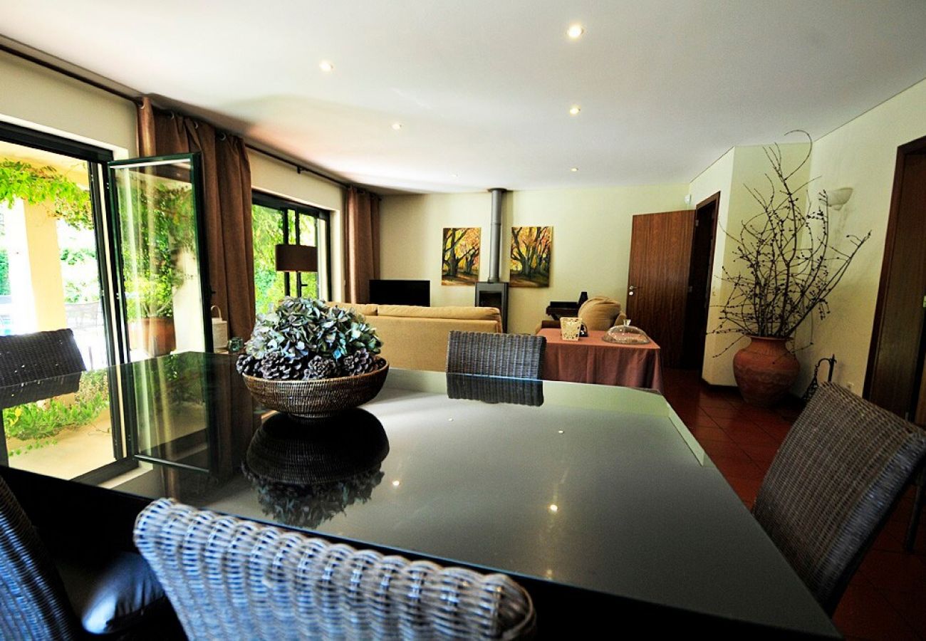 Salle à manger avec portes-fenêtres donnant sur la piscine