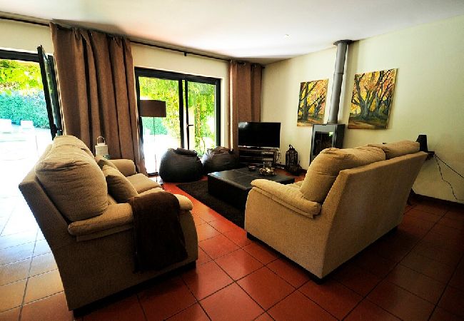 Living room with comfortable sitting, fireplace and patio doors to the swimming pool